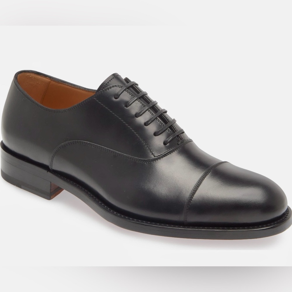 Lace-up style cap toe Italian-made designer shoe - polished fine-grain leather.